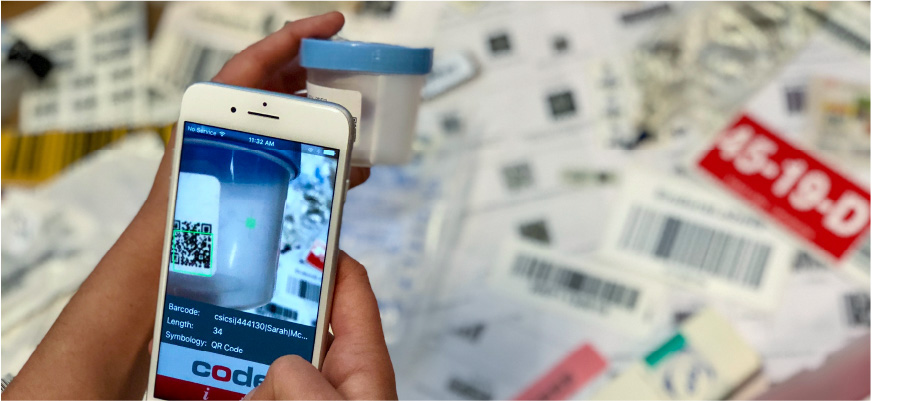 A smartphone screen is shown as the phone scans a barcoded container